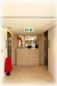 a hallway of a building with a room with plants at The Salvation Army - Booth Lodge in Hong Kong