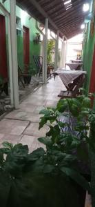 a patio with benches and a plant in a building at Pousada Ribeirinha in Aparecida