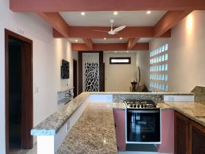 a kitchen with a counter and a stove top oven at Villa Marina in Arraial d'Ajuda