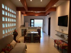 a living room with a table and a dining room at Villa Marina in Arraial d'Ajuda