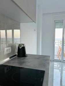 a kitchen with a counter top with a pot on it at Chrisanthi Apartments in Archangelos +13 photos