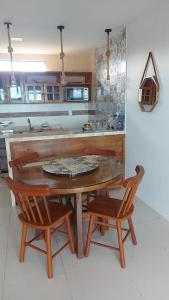 a kitchen with a wooden table and two chairs at Apbananeiras - Condomínio Sonhos da Serra in Bananeiras