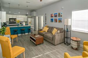 a living room with a couch and a kitchen at Baycation on Arch in Tampa