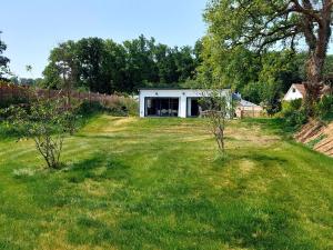 a house in the middle of a yard at Apple Lodge in Bovey Tracey