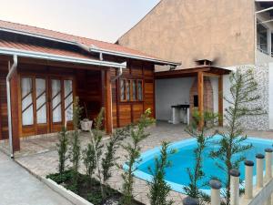 a house with a swimming pool in front of it at Casa do Kélvio in Penha