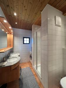 a bathroom with two sinks and a shower at Panorama View Apartments Nassfeld in Hermagor