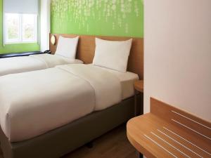 Postel nebo postele na pokoji v ubytování Zest Bogor by Swiss-Belhotel International