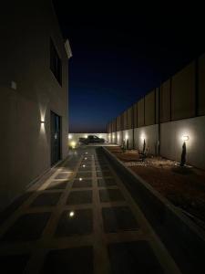 an empty building at night with a car in the distance at The Mansion villa in Al Rama