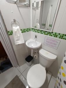 a bathroom with a white toilet and a sink at Apêzinho Vidigal - RJ in Rio de Janeiro +44 photos