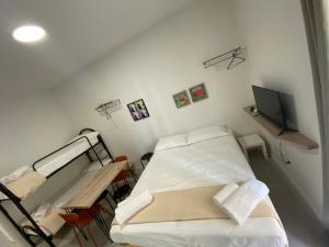 a hospital room with a bed and a flat screen tv at San Dionigi 11 Studio Apartments in Milan