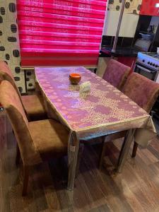 a table with a pink table cloth on it at BakuHome in Baku