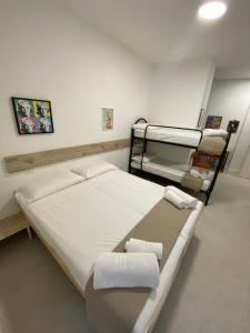 a room with two bunk beds with towels at San Dionigi 11 Studio Apartments in Milan