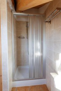 a shower with a glass door in a bathroom at Casa Giulia in Bormio