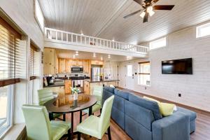 a living room with a blue couch and a table at Cozy Texas Retreat with Covered Deck and Private Pond! in Lexington