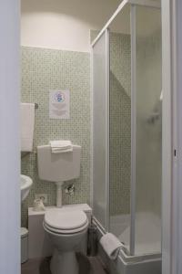 a small bathroom with a toilet and a shower at Domus Crescenzio - Guest House in Rome