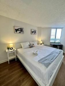 a large white bed in a bedroom with a window at Incredible Apartment with Rooftop in Pentagon City in Arlington