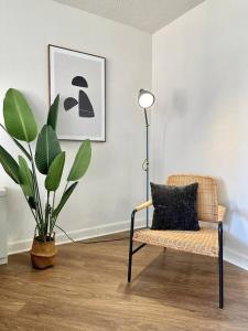 a room with a chair and a plant and a lamp at Incredible Apartment with Rooftop in Pentagon City in Arlington
