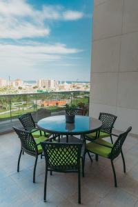 a table and chairs on a balcony with a view at Special VIP Mariott Apartment in Baku