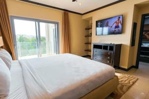ハコにあるLuxury beach condo, stunning sunset & ocean viewのベッドルーム(ベッド1台、薄型テレビ付)