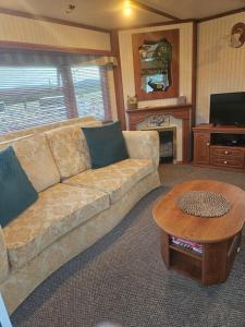 a living room with a couch and a coffee table at Mount bolton mobile home in Portlaw