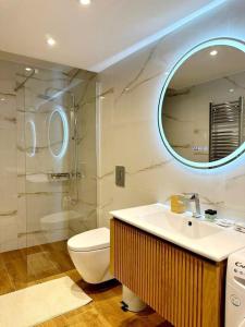 a bathroom with a sink and a toilet and a mirror at Moschato New Home 3 vipgreece in Piraeus