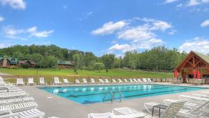 a swimming pool with lounge chairs and a pavilion at Paradise Found, Hot Tub, Mtn Views, Game Room, 560 FREE tickets each paid day! in Sevierville