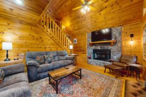 a living room with a couch and a fireplace at Sleepy Bear Hideaway in Mineral Bluff