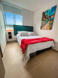a bedroom with a bed and a large window at Century in Sabaneta