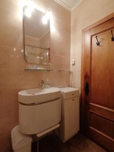 a bathroom with a sink and a mirror at ROSAS DA GRANJA - CASA DE CAMPO in Granja