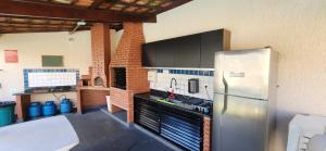 a kitchen with a stainless steel refrigerator in a room at SAN REMO in Guarujá