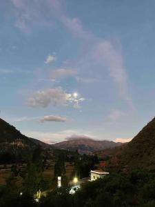 a view of a city with mountains in the background at Ecolodge las tunas in Cusco