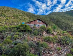 a barn on the side of a hill at Ecolodge las tunas in Cusco