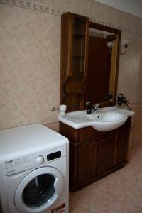 a bathroom with a washing machine and a sink at Residenza Il Conte in Nocera Umbra +29 photos