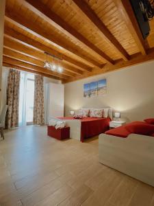 a large bedroom with a bed and a couch at La Vie Fuille Bed and Breakfast in Riposto