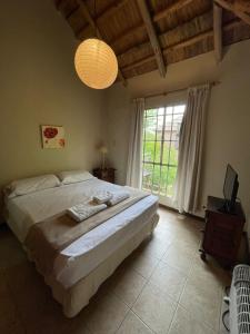 a bedroom with a large bed and a large window at don isidro cabaña alta in La Paz