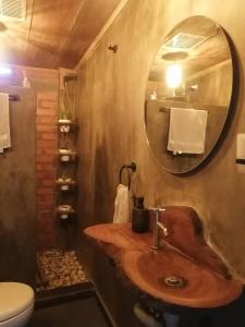 a bathroom with a wooden sink and a mirror at Pistacho in Minca