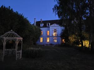 a white house with a gazebo in front of it at Saint-Eusèbe Mansion - Hôtel Particulier St-Eusèbe in Auxerre