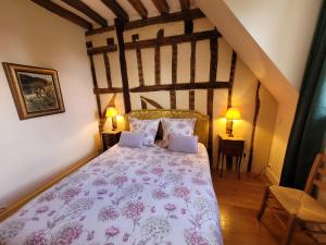 a bedroom with a large bed in a attic at Saint-Eusèbe Mansion - Hôtel Particulier St-Eusèbe in Auxerre +72 photos