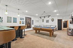 a living room with a pool table and a couch at Luxe Lake Home Reflect Recharge and Reconnect in Nine Mile Falls +109 photos