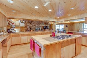 a large kitchen with wooden cabinets and a stove top oven at Spacious Dolores Vacation Rental with Decks and Views! in Dolores