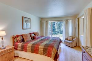 a bedroom with a bed and a window and a chair at Spacious Dolores Vacation Rental with Decks and Views! in Dolores