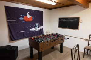 a game room with a table and a board at Athens and Albany's Hillside Haven in Albany
