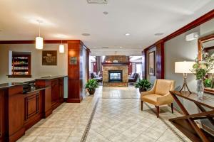 a living room with a fireplace and a table and chairs at Homewood Suites by Hilton Stratford in Stratford +33 photos