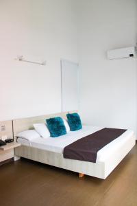 Ένα ή περισσότερα κρεβάτια σε δωμάτιο στο BGA Hotel