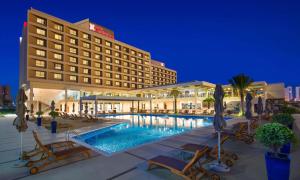 un hotel con piscina frente a un edificio en Hilton Garden Inn Ras Al Khaimah, en Ras al Khaimah