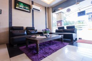 a living room with a couch and a coffee table at Lavender Inn Permas Jaya in Johor Bahru