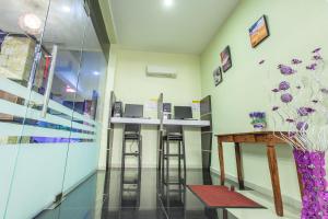 a bar in a room with stools at Lavender Inn Permas Jaya in Johor Bahru