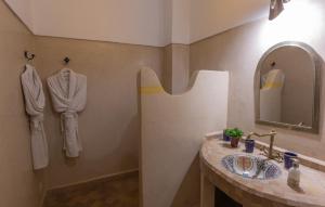 a bathroom with a sink and a mirror at Les Sources Berbères Riad & Spa in Marrakesh