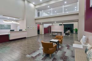 an empty lobby of a hospital with chairs and a table at Magnolia Pointe; BW Signature Collection in Sarasota