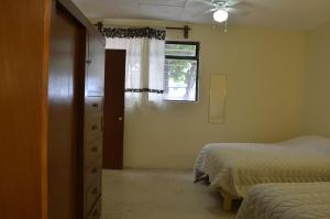 a bedroom with two beds and a window and a dresser at Casa Shanti Oaxaca in Oaxaca City